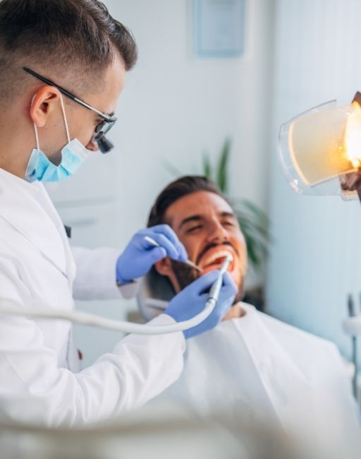 A dentist providing urgent care to a patient