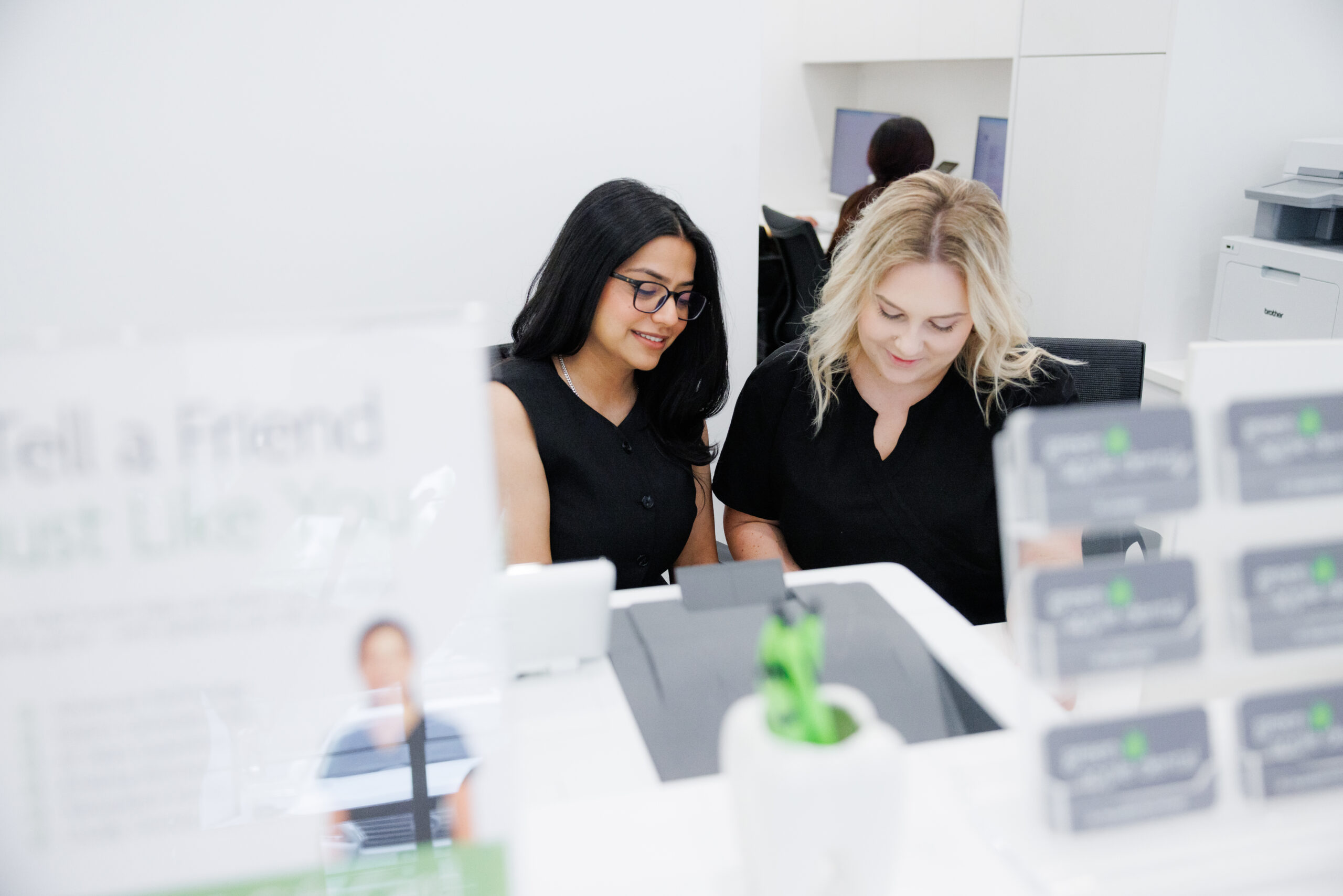 Two Green Apple Dental team members at the front desk