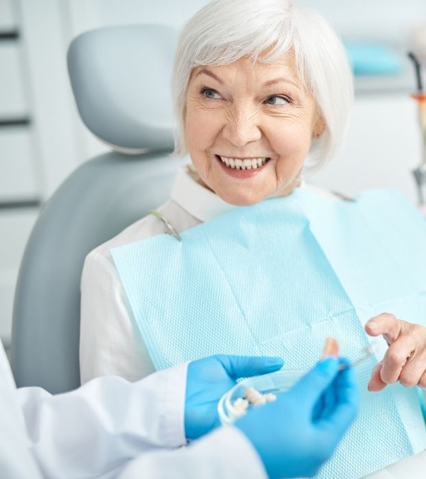 A senior patient smiling in the dental chair