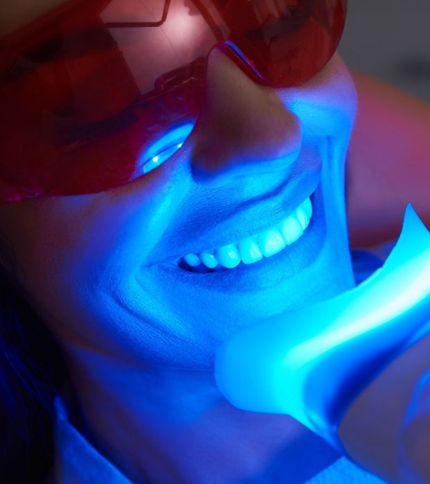 A patient receiving a UV teeth-whitening treatment