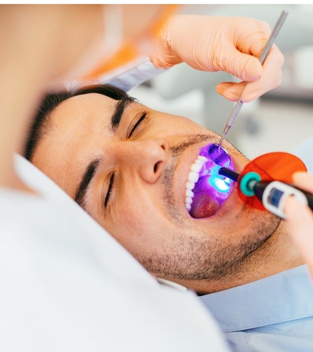 A patient having dental sealants light-cured