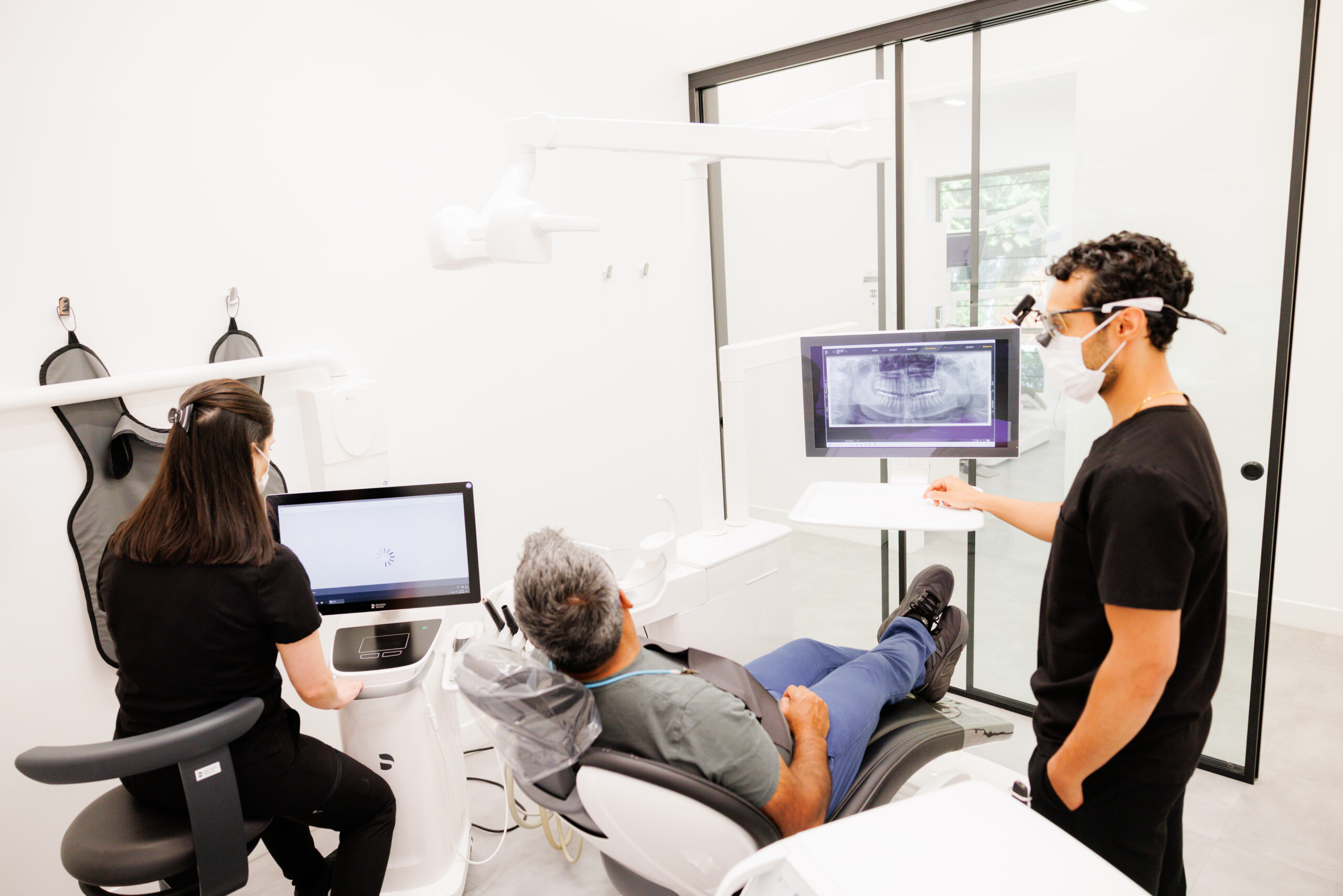 A dentist reviewing a 3D scan with a patient